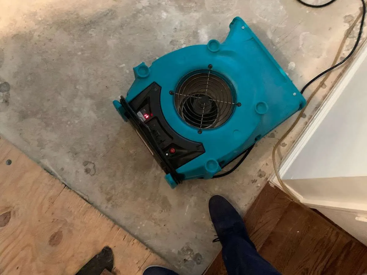 Air mover drying subfloor during Commercial Water Damage Restoration in Orland Hills